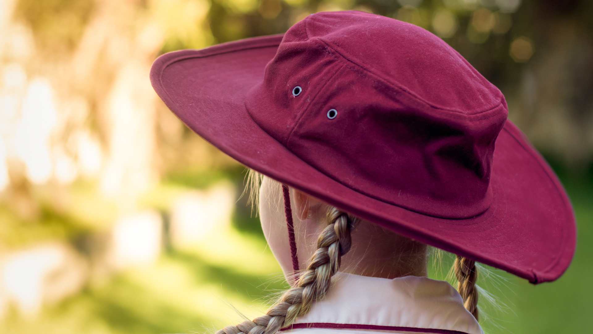 Girl wearing marroon coloured school hat
