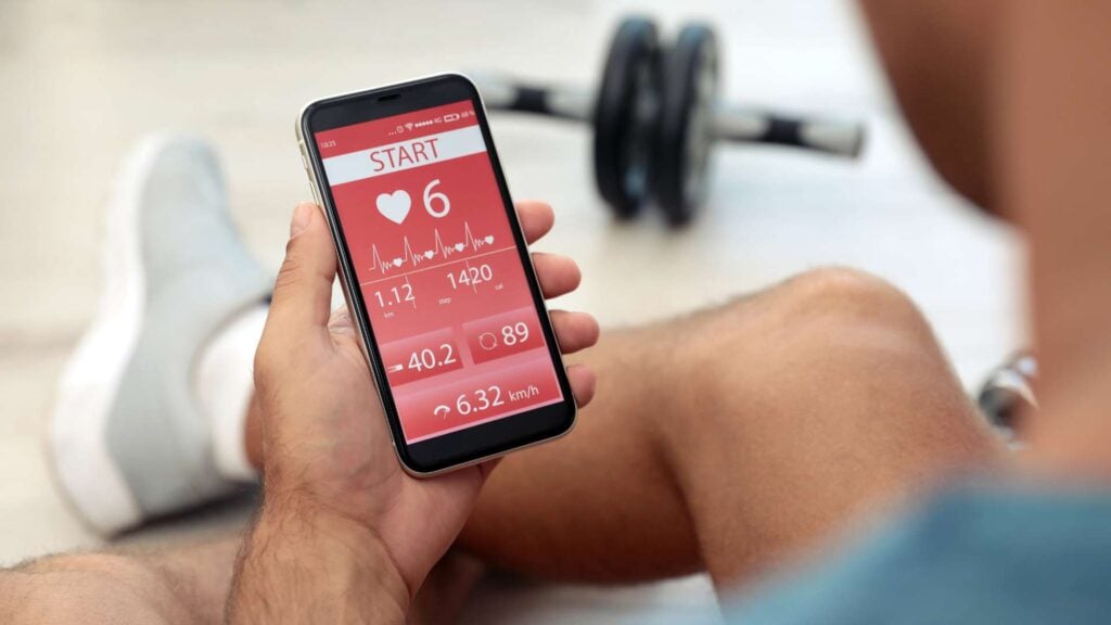 Man checking fitness app on a phone after a workout