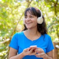 Person wearing headphones listening to music while walking outdoors