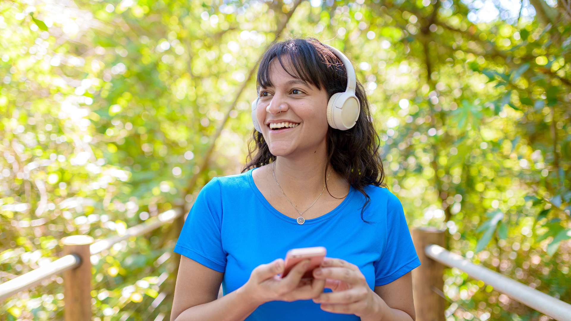 Person wearing headphones listening to music while walking outdoors