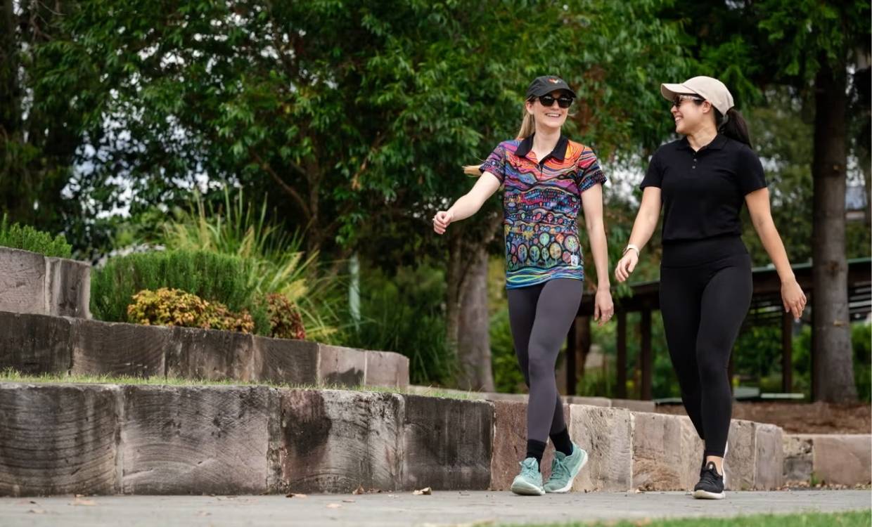 Two women walk oudoors together