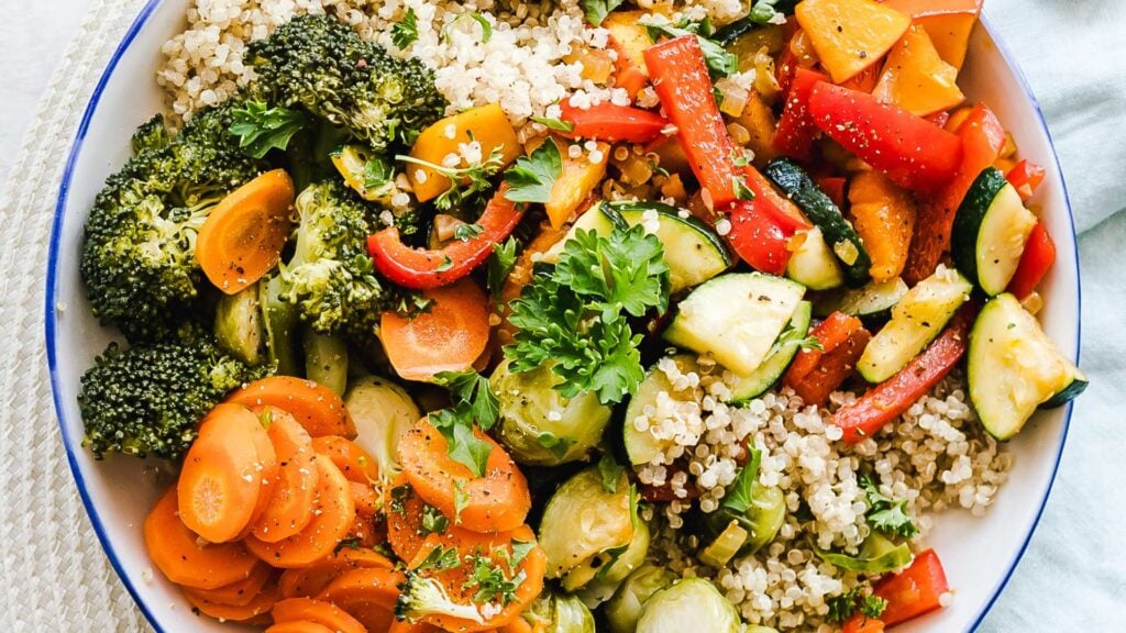 Healthy meal of colourful cooked vegetables and quinoa in a bowl