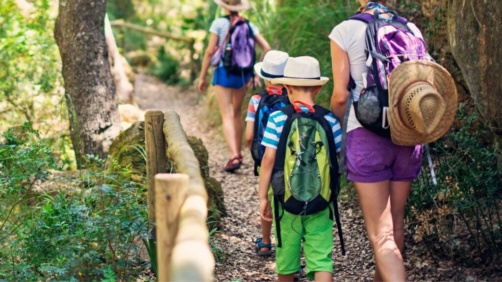 Woman and kids go on a hike together
