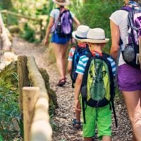 Woman and kids go on a hike together