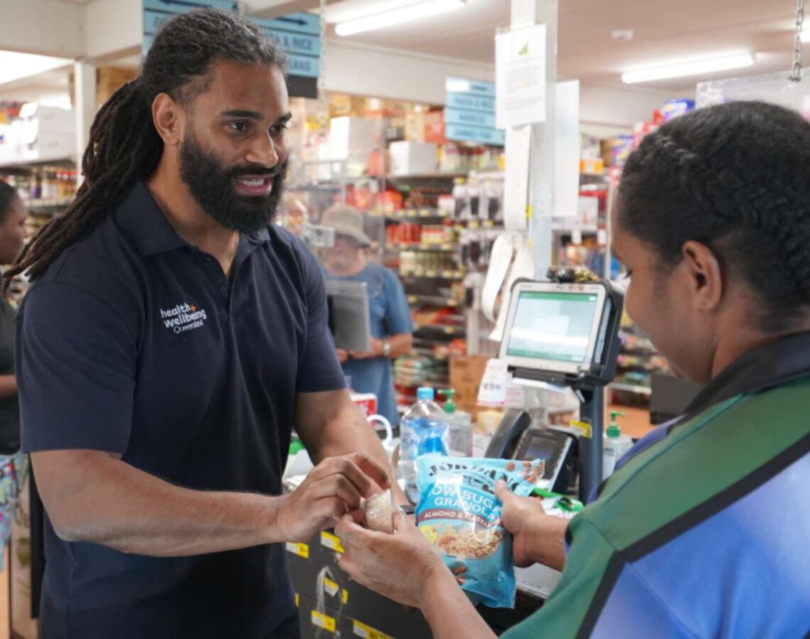 Two people at the Bamaga grocery store checkout in Far North Queensland