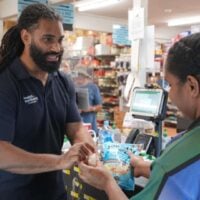 Two people at the Bamaga grocery store checkout in Far North Queensland