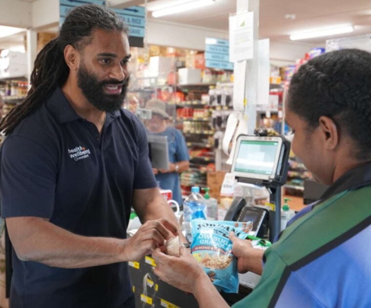 Two people at the Bamaga grocery store checkout in Far North Queensland