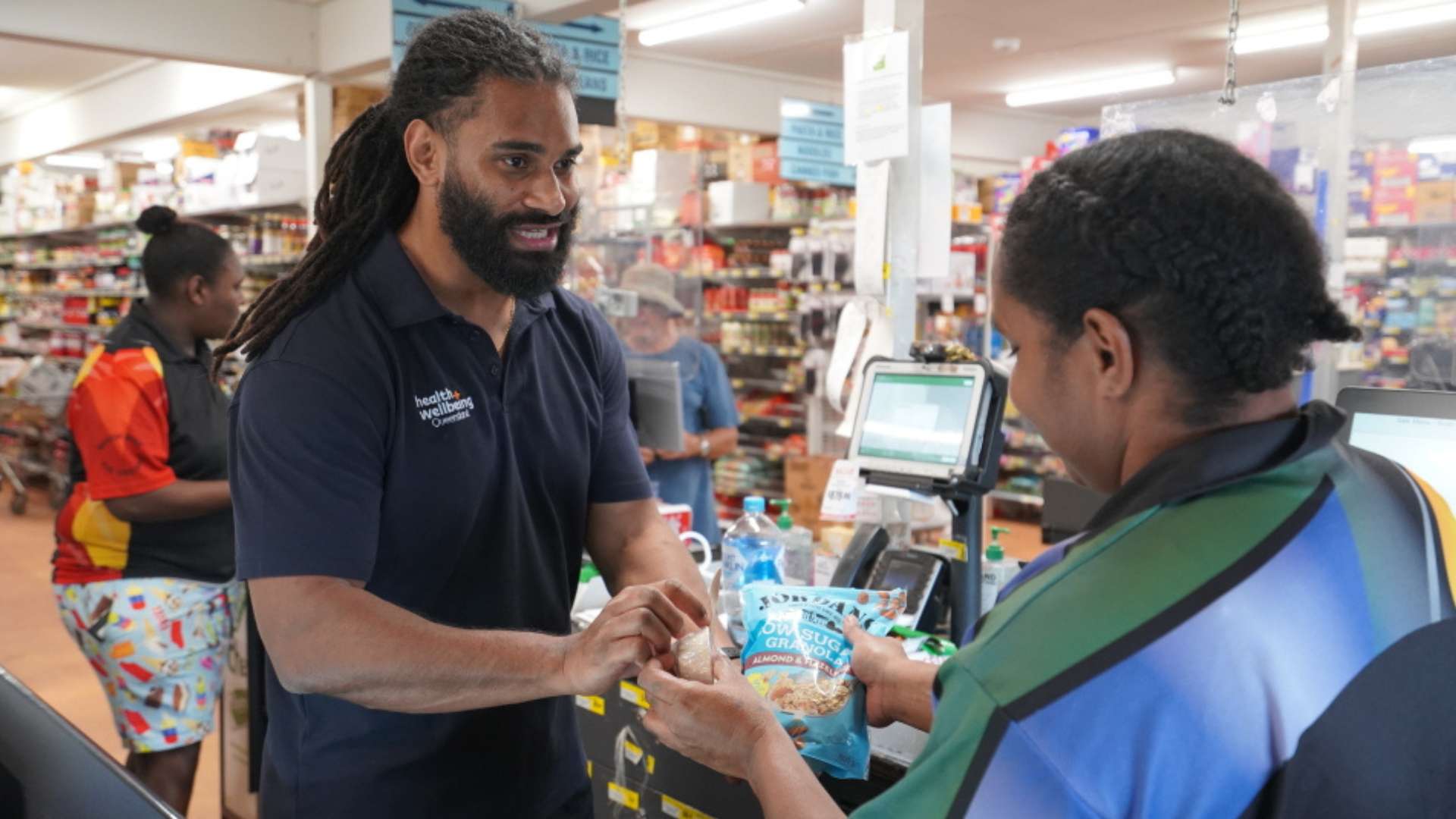 Two people at the Bamaga grocery store checkout in Far North Queensland