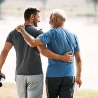Two men support one another