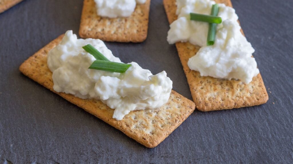 Healthy snack of cottage cheese on a multigrain cracker