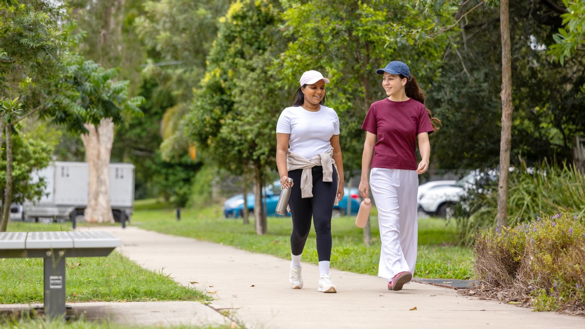 Two women walk along a footpath together