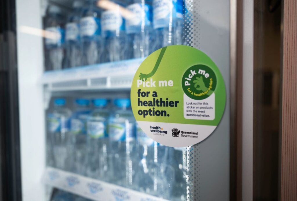Fridge filled with water with a Pick me sticker on the glass
