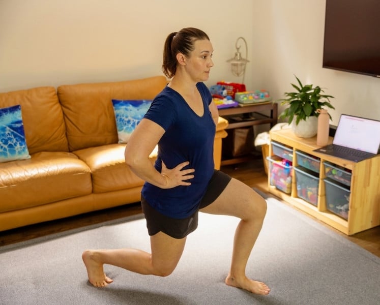 Female doing lunges in lounge room for stability, strength and balance