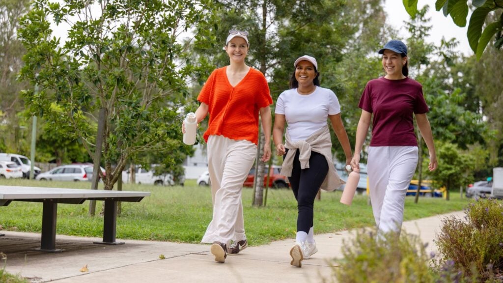 3 women walk together outside