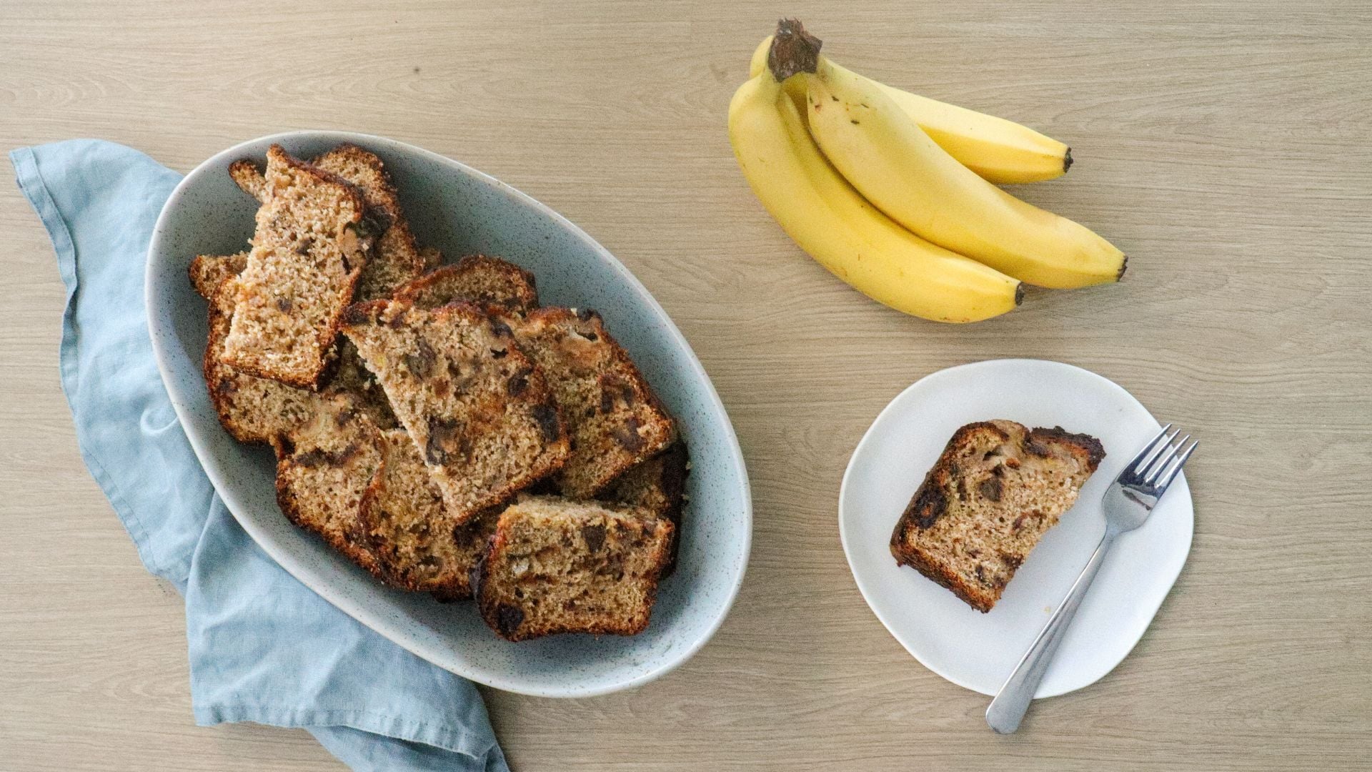 Slices of banana bread in a bowl, with one slice on a plate