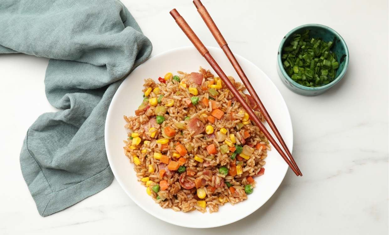 Fried rice on a plate with chopsticks