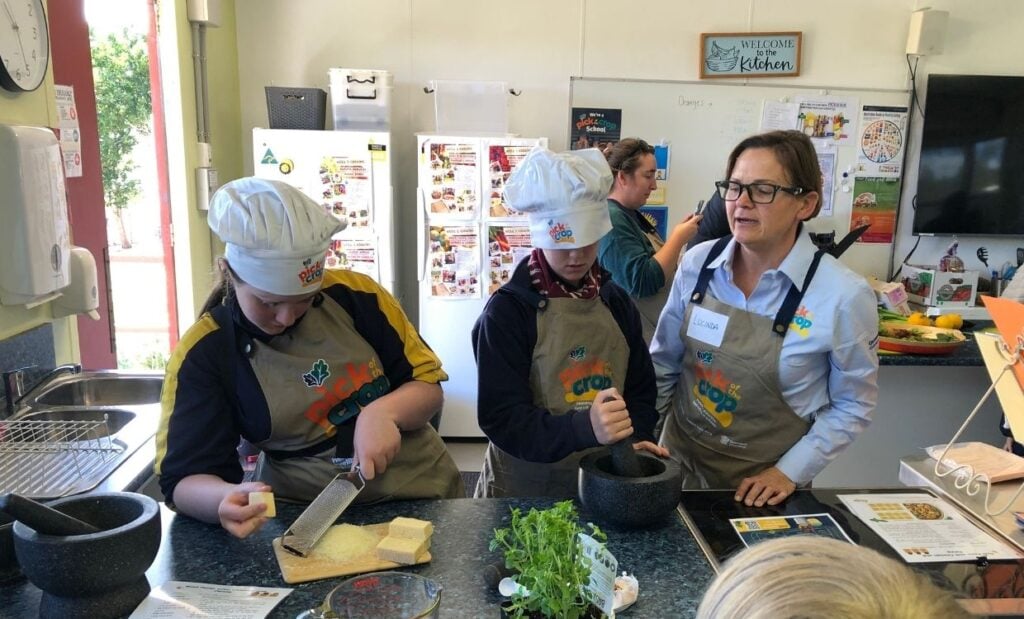 Students prepare food in school kitchen as part of Pick of the Crop Kitchen Day