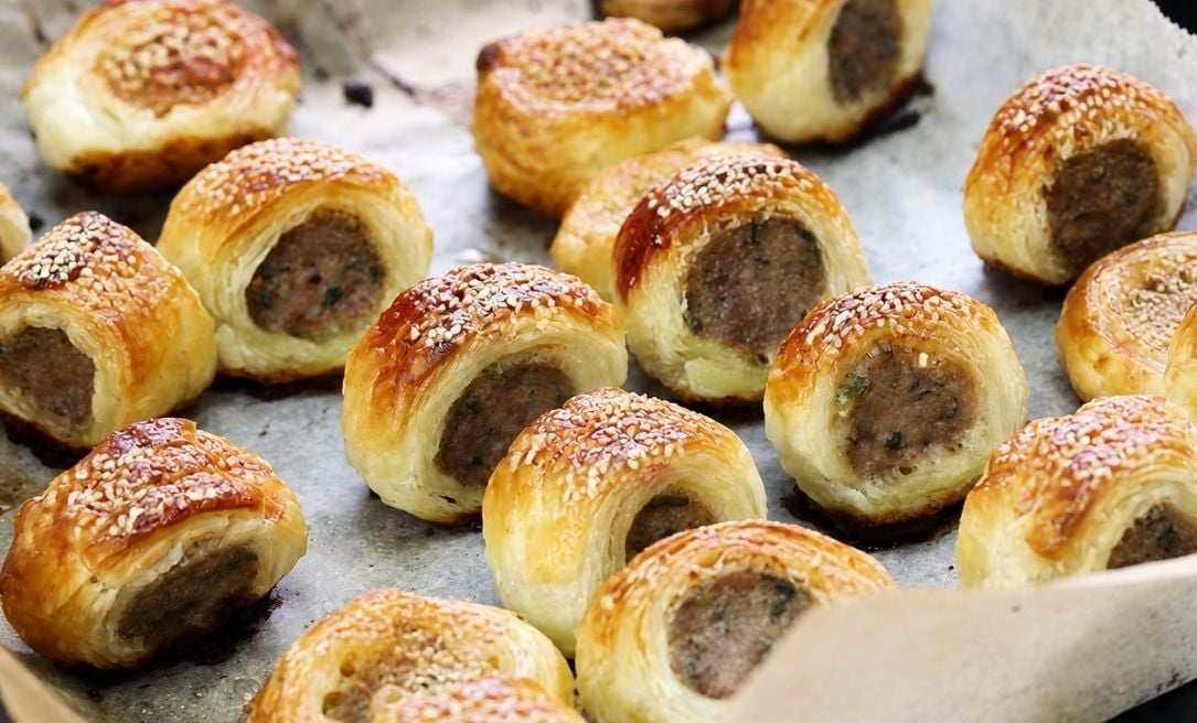 Bite sized healthy sausage rolls on a baking tray