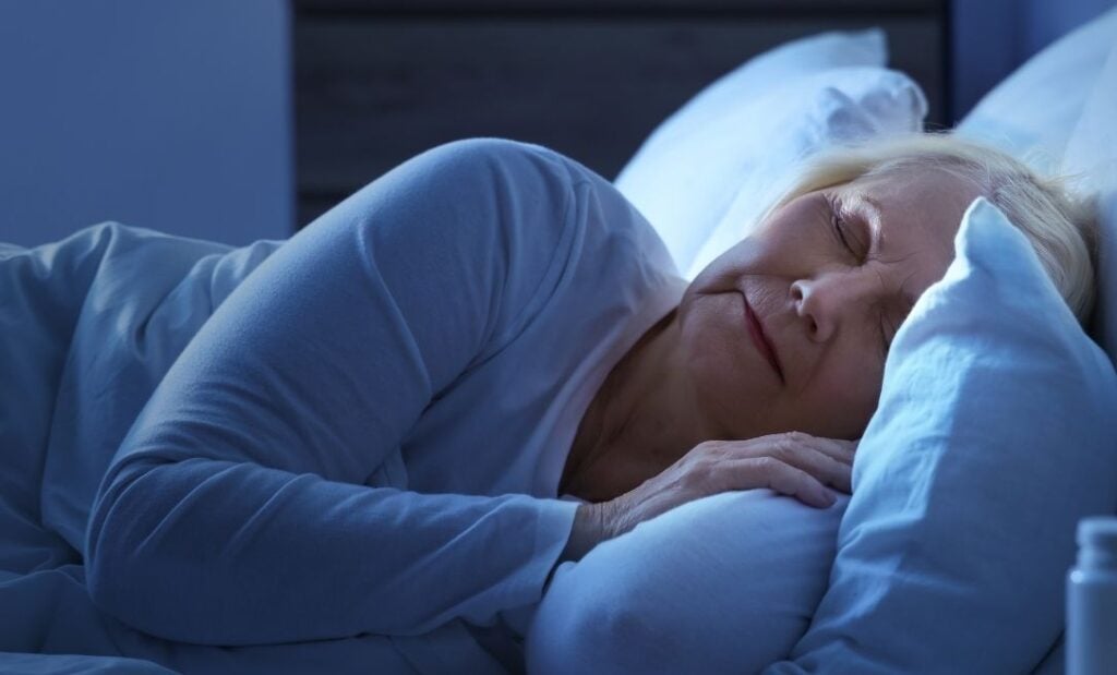 Older woman sleeps soundly in bed