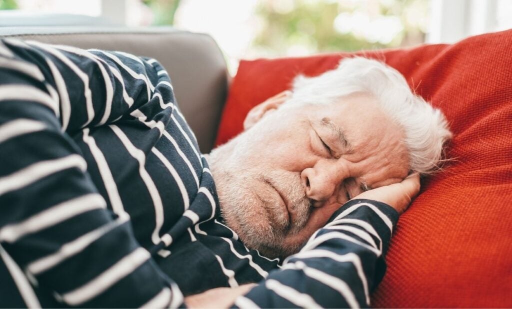 Older man naps on the couch